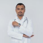 Portrait of a confident doctor in a white coat with a stethoscope, symbolizing healthcare professionalism.